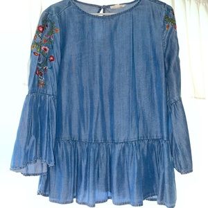 Jean like material. Flower detail on sleeve.